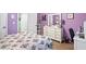 Purple bedroom with a queen bed and white dresser at 430 Flowering Trl, Grayson, GA 30017