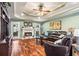 Relaxing living room with hardwood floors, a fireplace, and a ceiling fan at 430 Flowering Trl, Grayson, GA 30017