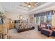 Relaxing main bedroom with ceiling fan and sitting area at 430 Flowering Trl, Grayson, GA 30017