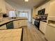 Bright kitchen with white cabinets, tile countertops, and stainless steel appliances at 733 Exchange Mill, Dacula, GA 30019