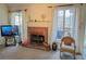 Cozy living room with brick fireplace and large windows at 733 Exchange Mill, Dacula, GA 30019