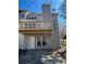 Rear view of home shows elevated wooden deck, downstairs patio area, and backyard, perfect for enjoying the outdoors at 1699 Paddlewheel Dr, Marietta, GA 30062