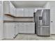Kitchen features white cabinets, stainless steel appliances, and tile flooring at 1699 Paddlewheel Dr, Marietta, GA 30062