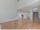 Open living room with hardwood floors and view of kitchen and stairs at 1699 Paddlewheel Dr, Marietta, GA 30062