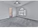 Main bedroom with grey carpet, ceiling fan and arched window at 1699 Paddlewheel Dr, Marietta, GA 30062