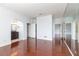Large bedroom features hardwood floors, arched doorway, and large wall mirror at 2499 Peachtree Ne Rd # 504, Atlanta, GA 30305