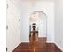Hallway with hardwood floors leads to a white kitchen with stainless steel appliances at 2499 Peachtree Ne Rd # 504, Atlanta, GA 30305