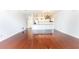 Open-concept living area featuring hardwood floors, modern lighting, and a white kitchen at 2499 Peachtree Ne Rd # 504, Atlanta, GA 30305