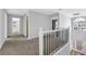 Upstairs hallway with carpet and view of chandelier and a staircase at 5030 Mundy Dr, Cumming, GA 30028