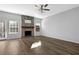 Cozy living room with hardwood floors, fireplace and a ceiling fan at 5030 Mundy Dr, Cumming, GA 30028