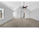 Large main bedroom featuring vaulted ceilings, fan, and open access to the ensuite bathroom at 5030 Mundy Dr, Cumming, GA 30028