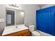 Simple bathroom with wood vanity and blue shower curtain at 516 Fairlane Nw Cir, Atlanta, GA 30331