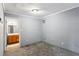 Gray-walled bedroom with carpet and access to bathroom at 516 Fairlane Nw Cir, Atlanta, GA 30331