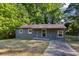 Gray brick ranch house with a tree-lined yard at 516 Fairlane Nw Cir, Atlanta, GA 30331