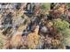 Aerial view of a home nestled amongst mature trees and a large lot at 175 Highland Cir, Mcdonough, GA 30253