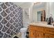 Bright bathroom features a vanity sink, toilet and patterned shower curtain at 175 Highland Cir, Mcdonough, GA 30253
