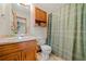 A functional bathroom includes a shower with a curtain and wood cabinets at 175 Highland Cir, Mcdonough, GA 30253
