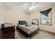 Cozy bedroom with grey carpet, a ceiling fan, and a large window at 175 Highland Cir, Mcdonough, GA 30253