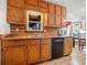 Bright kitchen boasts wooden cabinets and drawers, and a stainless steel dishwasher at 175 Highland Cir, Mcdonough, GA 30253