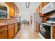A well-lit kitchen includes wood cabinets, tile floors and stainless steel appliances at 175 Highland Cir, Mcdonough, GA 30253