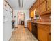 Functional kitchen featuring wood cabinets and a view into the laundry room at 175 Highland Cir, Mcdonough, GA 30253