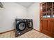 A laundry room features new appliances and a wooden door and trim at 175 Highland Cir, Mcdonough, GA 30253