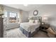 Serene bedroom featuring soft colors, hardwood floors, a large window, and stylish furnishings at 1979 Flying Scotsman Dr # 16, Kennesaw, GA 30144