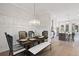 Well-lit dining room features modern chandelier, wainscoting, and seamless transition to kitchen at 1979 Flying Scotsman Dr # 16, Kennesaw, GA 30144