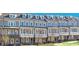 Attractive townhome exteriors with covered porches and manicured lawns at 1979 Flying Scotsman Dr # 16, Kennesaw, GA 30144