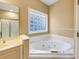 Relaxing bathroom with a corner jacuzzi tub at 1120 Graystone Xing, Alpharetta, GA 30005