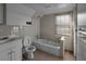 Small bathroom with white tub and sink at 1142 Cahaba Dr, Atlanta, GA 30311
