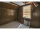 Small bedroom with wood paneling and a window at 1142 Cahaba Dr, Atlanta, GA 30311
