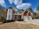 Two-story house with brick and siding, two-car garage, and landscaped yard at 1745 Collines Sw Ave, Atlanta, GA 30331