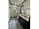 Stylish bathroom with black vanity, herringbone tile shower, and patterned floor at 190 Carl Sanders Dr, Acworth, GA 30101