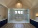 Spa-like bathroom with marble finishes and chandelier at 190 Carl Sanders Dr, Acworth, GA 30101