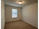 Spacious bedroom with neutral walls, carpet flooring, and a window with blinds at 2116 Stillhaven Pl, Douglasville, GA 30135