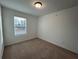 Bright bedroom with neutral walls, carpet flooring, and a window with blinds at 2116 Stillhaven Pl, Douglasville, GA 30135