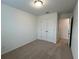 Bright bedroom with carpet flooring and double door closet at 2116 Stillhaven Pl, Douglasville, GA 30135