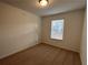 Bright bedroom with neutral walls, carpet flooring, and a window with blinds at 2116 Stillhaven Pl, Douglasville, GA 30135