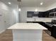 Modern kitchen island with white quartz countertops and dark cabinetry at 2116 Stillhaven Pl, Douglasville, GA 30135