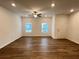 Living room with hardwood floors, ceiling fan, and door at 2116 Stillhaven Pl, Douglasville, GA 30135