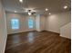 Living room with hardwood floors, ceiling fan, and stairs at 2116 Stillhaven Pl, Douglasville, GA 30135