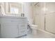 Updated bathroom with gray vanity, shower, and white toilet at 3312 Northcrest Rd # A, Atlanta, GA 30340