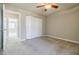 Bedroom with ceiling fan, carpet, large closet, and access to another room at 3312 Northcrest Rd # A, Atlanta, GA 30340