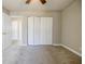 Bedroom with ceiling fan, carpet, large closet, and access to another room at 3312 Northcrest Rd # A, Atlanta, GA 30340