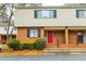 Brick front exterior of townhome with red door and landscaping at 3312 Northcrest Rd # A, Atlanta, GA 30340