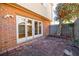 Brick patio with access from sliding glass doors, surrounded by a wooden fence and landscaping at 3312 Northcrest Rd # A, Atlanta, GA 30340