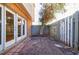 Small, private patio area enclosed by a wooden fence and featuring a flowering tree at 3312 Northcrest Rd # A, Atlanta, GA 30340