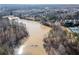 An aerial view of a lake surrounded by trees and homes at 333 Gardens Of Harmony Dr, Canton, GA 30115