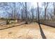 Large, unfenced backyard with mature trees and play swing at 333 Gardens Of Harmony Dr, Canton, GA 30115